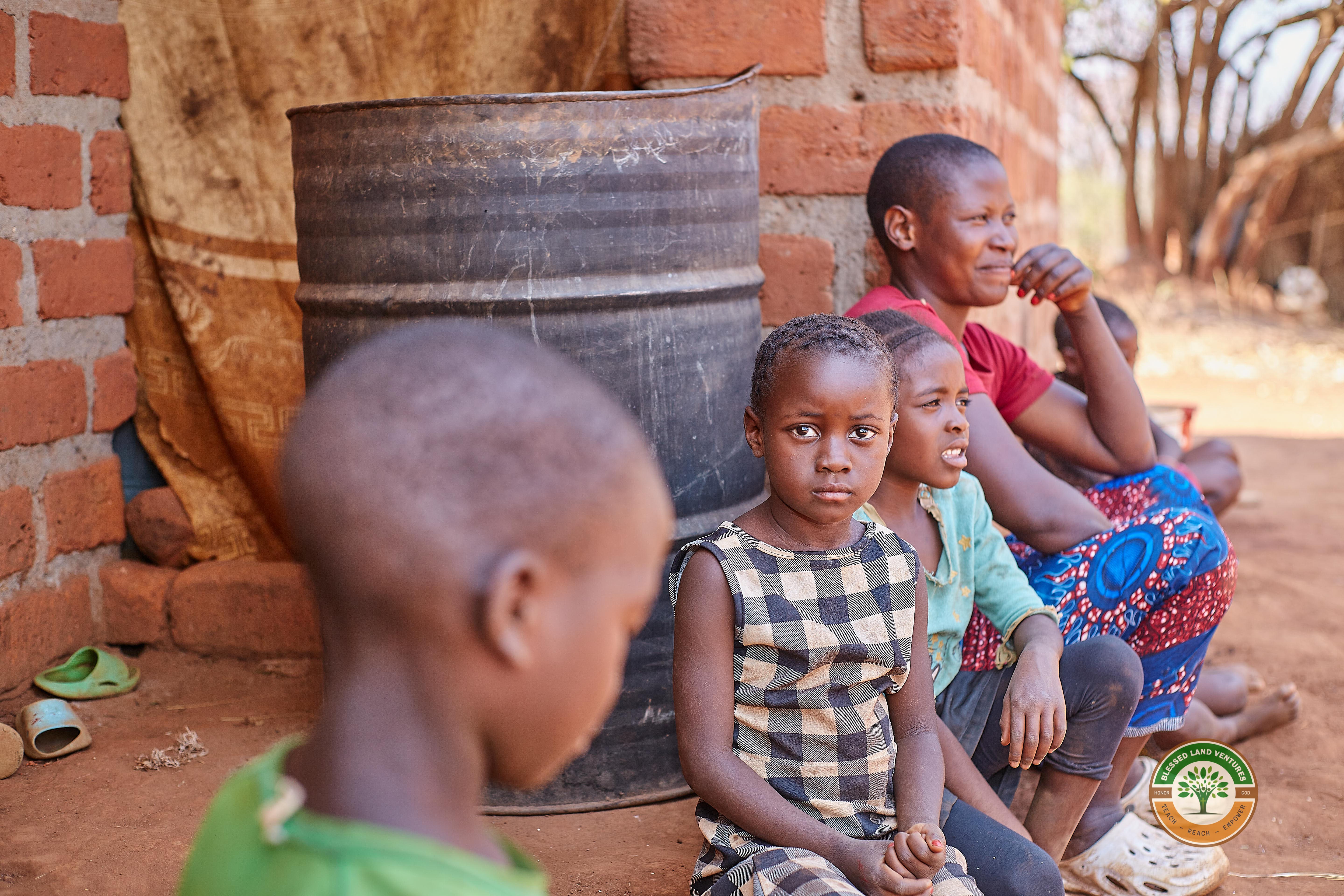 A family outside their home in rural Zambia